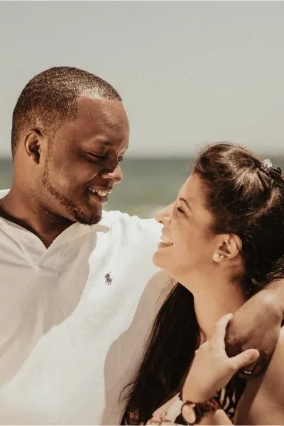A couple laughing together at the beach